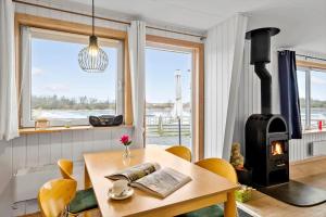 a dining room with a table with a wood stove at JB380-Fjerritslev-Gottrupvej-311-C in Fjerritslev