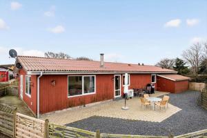 a red house with a patio in front of it at JB380-Fjerritslev-Gottrupvej-311-C in Fjerritslev