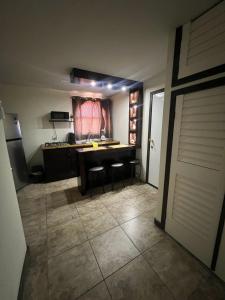 a kitchen with a table and chairs in a room at Chocolate condo in San Felipe +2 photos