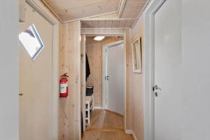 a tiny house with a hallway with a door at LL269-Tranekaer-Rollikevej-20-a in Stoense