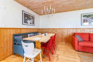 a dining room with a table and chairs and a couch at VMA945-Koeping-Avhulta-Gard-1 in Köping