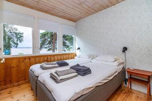 a bedroom with a large bed with towels on it at VMA945-Koeping-Avhulta-Gard-1 in Köping