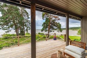 a deck with a bench and a view of the water at VMA945-Koeping-Avhulta-Gard-1 in Köping