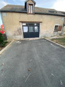 an empty parking lot in front of a garage at Le nid de la Brenne in Luant