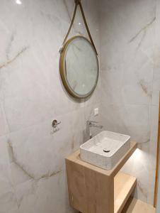 a bathroom with a sink and a mirror on the wall at katerina house in Ormos Panagias +9 photos