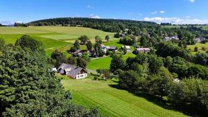 an aerial view of a house in a green field at Chalupa Lindenberg in Jestrabi V Krkonosich