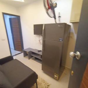 a kitchen with a stainless steel refrigerator in a room at Luna home in Petra