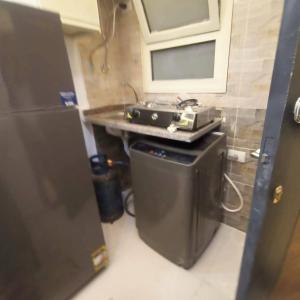 a kitchen with a stove and a sink in a room at Luna home in Petra +2 photos