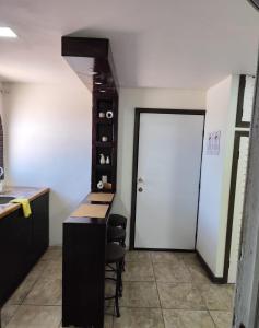 a kitchen with a white door and a table and chairs at Chocolate condo in San Felipe