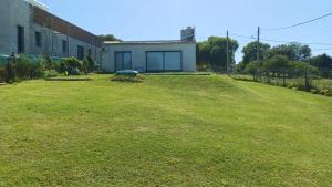 a large grassy yard next to a building at Casa Aramí in Victoria