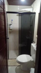 a bathroom with a toilet and a glass shower door at Chalé Privê Serrano em Gravatá in Gravatá +11 photos
