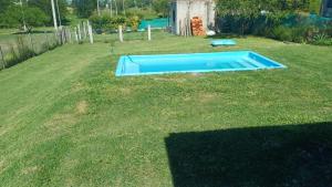 a small blue swimming pool in a yard at Casa Aramí in Victoria