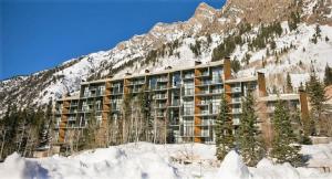a large building in front of a mountain at Condo Right on the Snowbird Slopes! in Sandy +15 photos