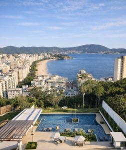 a view of a city and a swimming pool at Refúgio Serena in Niterói