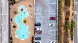 an overhead view of a parking lot with a swimming pool at Steps to the Sand - 1BR Condo in Panama City Beach