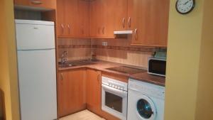 a kitchen with a white refrigerator and a dishwasher at Apartamento San Martín in Teruel