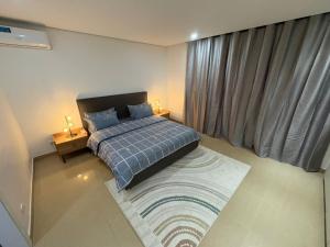 a bedroom with a bed and a large window at Studio B Luxury - Waterfront in Dakar +16 photos