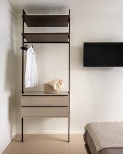 a bedroom with a dresser with a mirror and a bed at Casa Marella in Balestrate