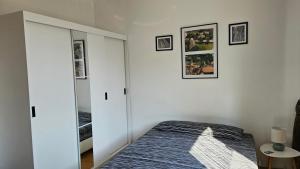 a bedroom with a bed and a mirror at Apartmán Centrum in Komárno