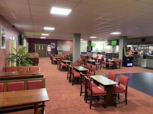a dining room with tables and chairs and a cafeteria at Sun, Sand & Sheppey The Ultimate Escape in Leysdown-on-Sea