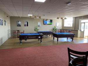 a room with two pool tables in a room at Sun, Sand & Sheppey The Ultimate Escape in Leysdown-on-Sea