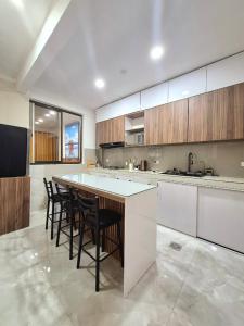 a large kitchen with a bar with chairs around it at Endless Salt in Colchani