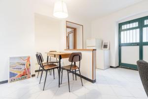 a dining room with a table and four chairs at Levanto lodge in Levanto +17 photos