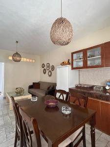 a kitchen and living room with a table and a couch at Fiosal Apartments 1 in Skiathos