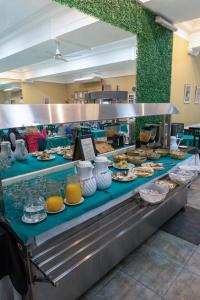a buffet line with plates of food on display at Hotel Miami in Mar del Plata