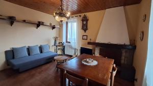 a living room with a blue couch and a table at La dimora del lago in Meina