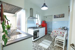 a kitchen with a sink and a stove top oven at La Valletta - Casa di Anna in Menaggio