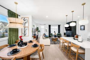 a kitchen and living room with a table and chairs at Sleeps 8 - Rooftop Deck - Prime Location in Raleigh
