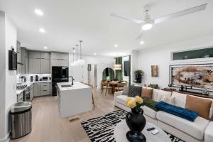 a living room and kitchen with a couch and a table at Sleeps 8 - Rooftop Deck - Prime Location in Raleigh