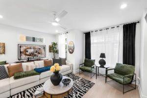 a living room with a couch and two chairs at Sleeps 8 - Rooftop Deck - Prime Location in Raleigh +44 photos