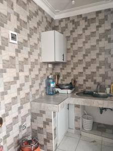 a kitchen with a sink and a counter top at Ardina Studio in Mtwapa