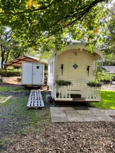 a small shed with a door and a trailer at Pipowagen in Haaksbergen