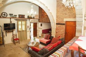a living room with a couch and a table at Traditional Villa with pool in Sfakia in Ímbros