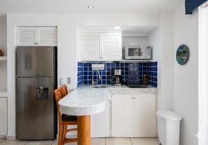 a kitchen with a counter and a refrigerator at Beachfront view Condo beside la Isla Mall in Puerto Vallarta