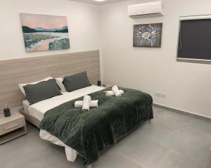 a bedroom with a bed with two towels on it at Brand New Seafront Apartment in Sliema +6 photos