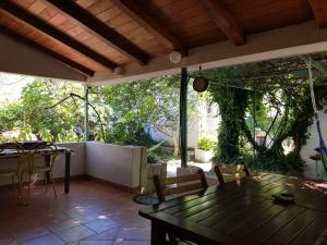a patio with a table and chairs and a tree at Apartments Vrtina in Igrane