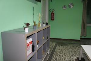 a cabinet in a room with green walls at Uddin House in Genoa +37 photos