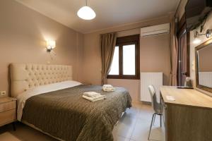 a bedroom with a bed with two towels on it at Elia Deluxe Accommodation in Kalabaka