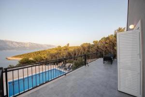 a balcony with a view of the water at Villa Azure Bay in Povlja