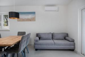 a living room with a couch and a table at Villa Azure Bay in Povlja