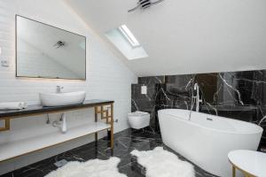a bathroom with a tub and a sink and a toilet at Villa Azure Bay in Povlja +29 photos