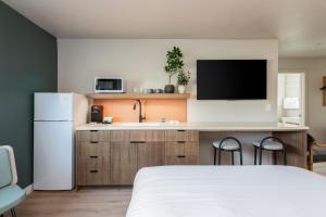 a kitchen with a bed and a sink and a refrigerator at Adobe Desert in Panguitch +17 photos