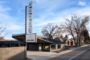 a sign for a hotel next to a building at Adobe Desert in Panguitch