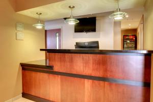 a lobby with a bar with a flat screen tv at Cobblestone Inn & Suites - Harvey in Harvey