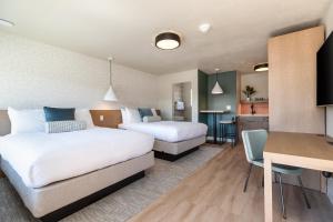 a hotel room with two beds and a kitchen at Adobe Desert in Panguitch