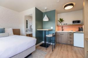 a bedroom with a bed and a small kitchen at Adobe Desert in Panguitch